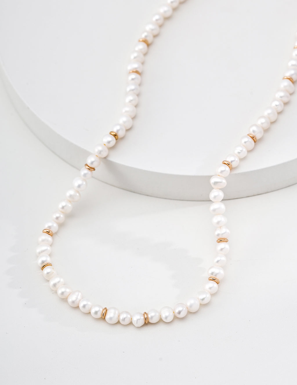 Minimalist Gold Rondelle Pearl Necklace - Draped on Steps